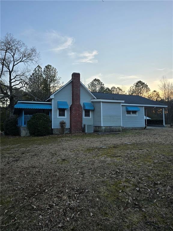 back house at dusk with a carport