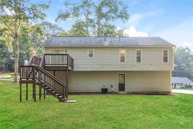 back of property featuring a yard, a wooden deck, and cooling unit