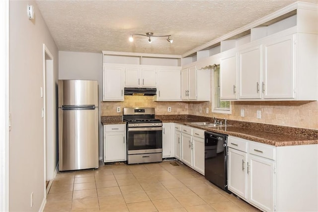 kitchen with light tile patterned floors, a textured ceiling, stainless steel appliances, and white cabinets