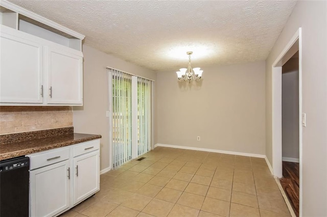 kitchen featuring dishwasher, a chandelier, white cabinetry, pendant lighting, and a textured ceiling