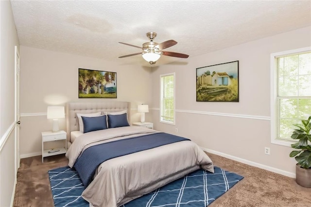 carpeted bedroom with multiple windows, ceiling fan, and a textured ceiling