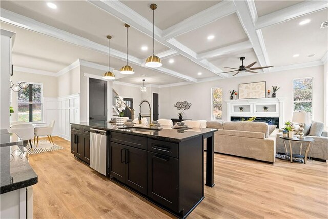 kitchen featuring coffered ceiling, ceiling fan, a sink, stainless steel dishwasher, and beamed ceiling