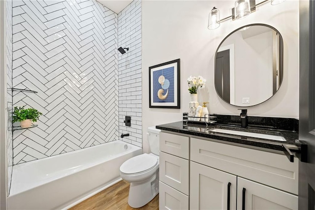 bathroom featuring vanity, shower / tub combination, toilet, and wood finished floors