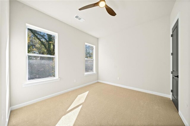 spare room featuring visible vents, baseboards, and a ceiling fan