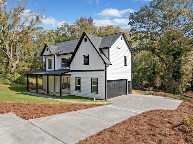 modern farmhouse style home featuring board and batten siding, a shingled roof, a porch, concrete driveway, and a garage