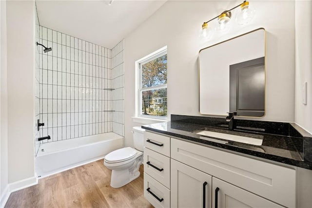 bathroom with toilet, vanity, bathtub / shower combination, and wood finished floors