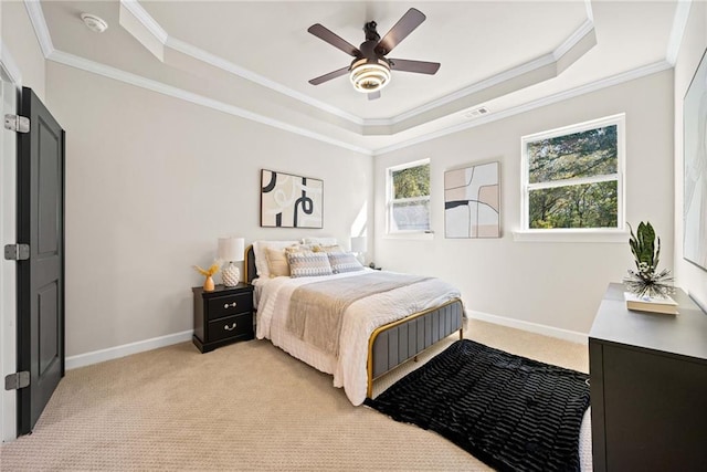 bedroom with light carpet, multiple windows, a raised ceiling, and baseboards