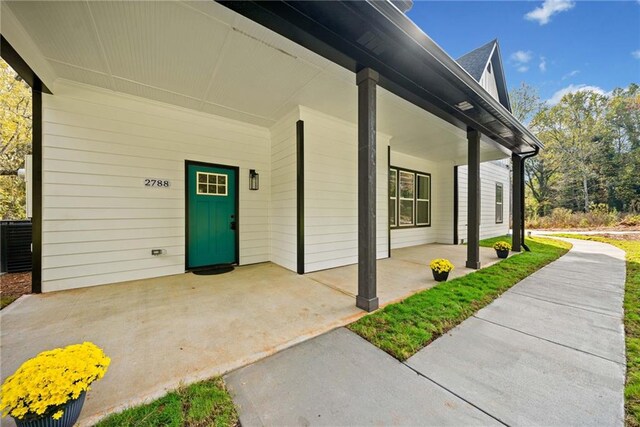 exterior space with central air condition unit and covered porch
