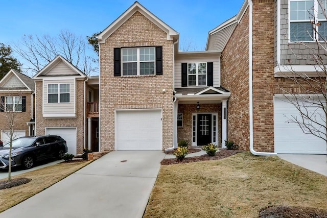 view of front of property featuring an attached garage, concrete driveway, a front lawn, and brick siding