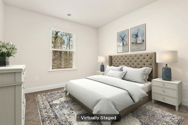 bedroom with carpet floors, baseboards, and visible vents