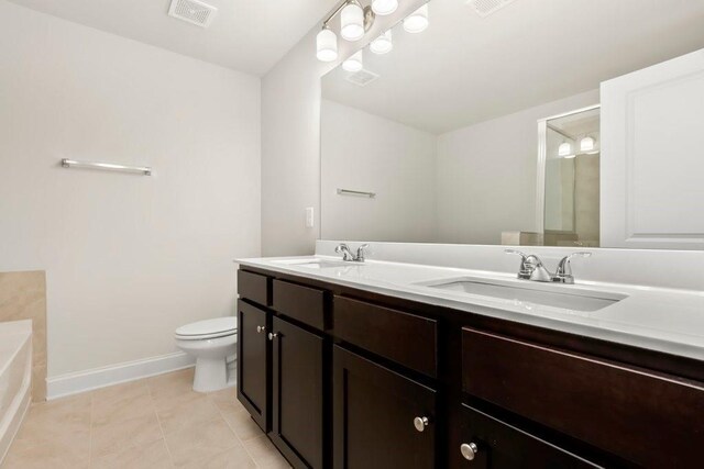 bathroom with toilet, baseboards, visible vents, and a sink