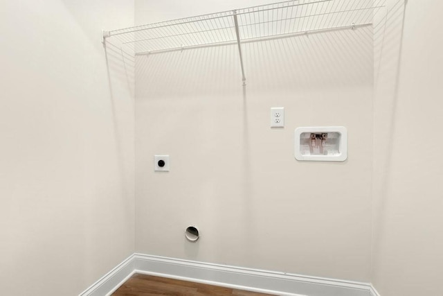 washroom with hookup for an electric dryer, laundry area, baseboards, hookup for a washing machine, and dark wood-type flooring