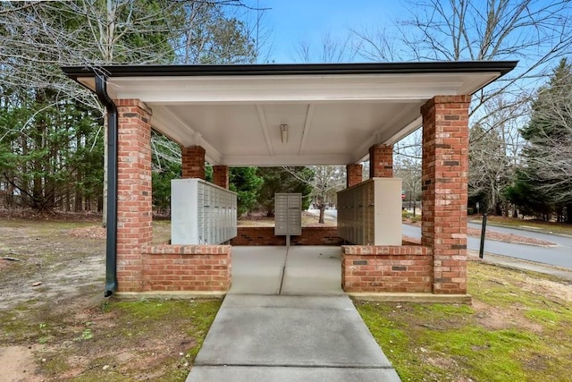 view of property's community with a carport and mail area