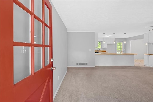 19 Quail Hollow Ct, Dallas, GA 30157 - unfurnished living room featuring a sink, light carpet, baseboards, and a textured ceiling