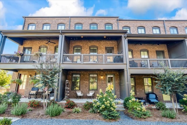 exterior space featuring a patio area, ceiling fan, and a balcony