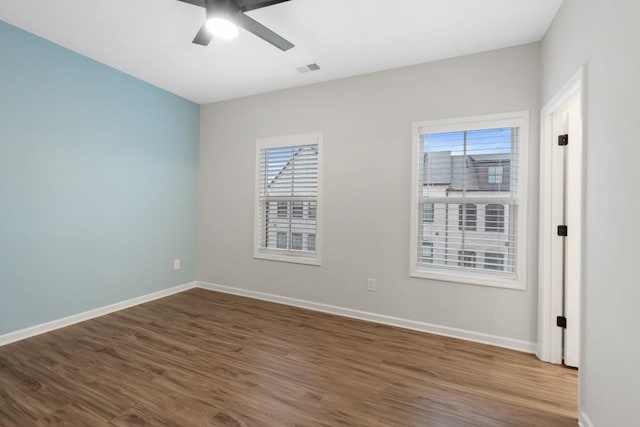 spare room featuring hardwood / wood-style floors, plenty of natural light, and ceiling fan