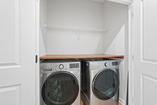 washroom with washing machine and clothes dryer