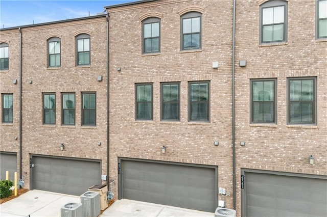 view of front facade with cooling unit and a garage