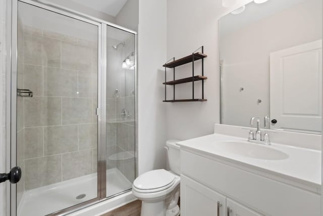 bathroom with wood-type flooring, vanity, toilet, and walk in shower