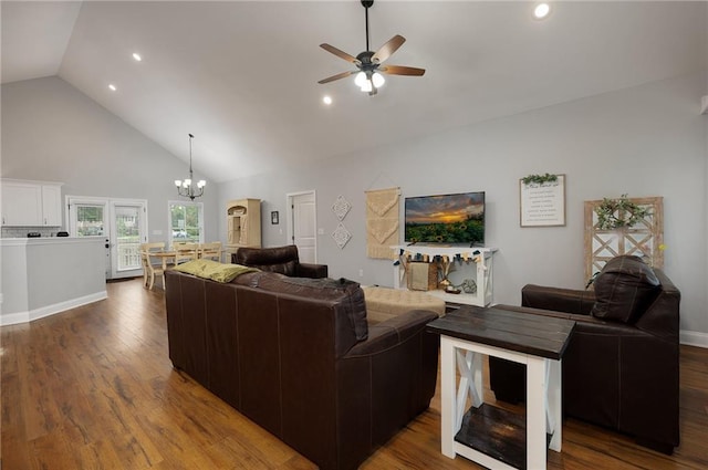 living area featuring high vaulted ceiling, ceiling fan with notable chandelier, recessed lighting, and wood finished floors