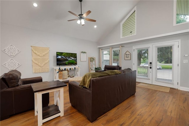 living room featuring hardwood / wood-style flooring, ceiling fan, french doors, high vaulted ceiling, and recessed lighting