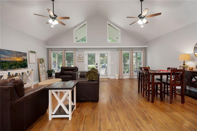 living area featuring a ceiling fan, a wealth of natural light, and light wood-style floors