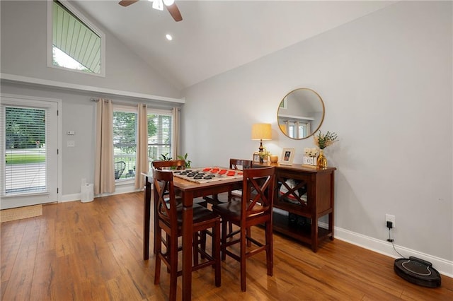 dining space featuring recessed lighting, a ceiling fan, wood finished floors, high vaulted ceiling, and baseboards