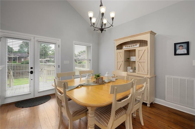 dining area with lofted ceiling, dark wood-style floors, visible vents, and french doors