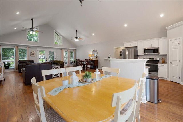 dining space featuring french doors, recessed lighting, light wood-style floors, ceiling fan, and high vaulted ceiling