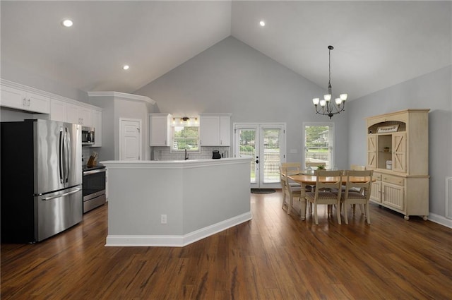 kitchen with dark wood-style flooring, decorative light fixtures, stainless steel appliances, light countertops, and white cabinetry