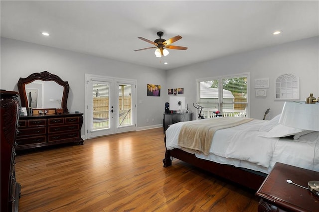 bedroom with access to exterior, recessed lighting, wood finished floors, and french doors