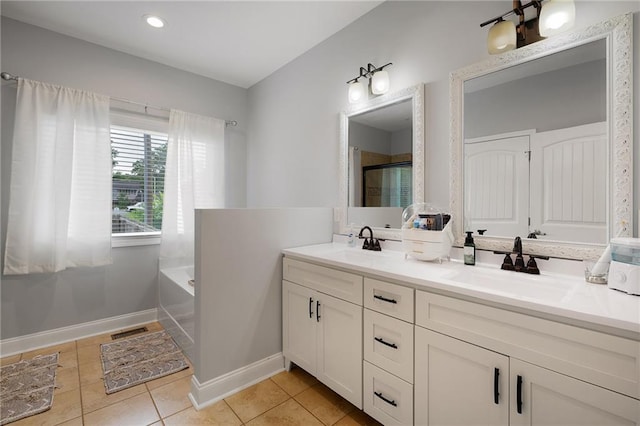 full bathroom with tile patterned flooring, a garden tub, a sink, and visible vents