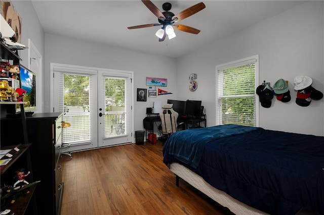 bedroom with access to exterior, multiple windows, dark wood finished floors, and french doors