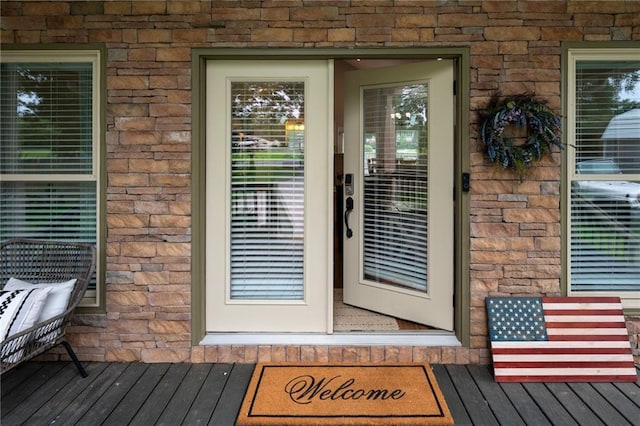 doorway to property with stone siding and brick siding