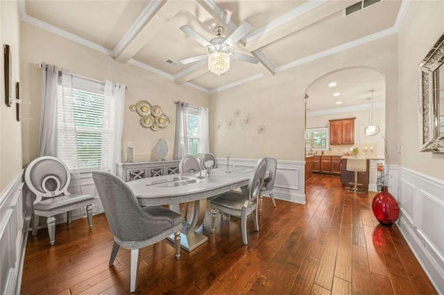 dining room with beamed ceiling, dark hardwood / wood-style flooring, coffered ceiling, ceiling fan, and crown molding