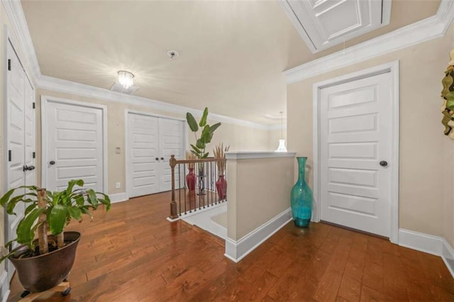 entryway with ornamental molding and dark wood-type flooring