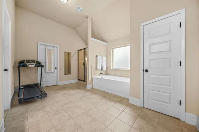 bathroom featuring tile patterned flooring, vaulted ceiling, and independent shower and bath