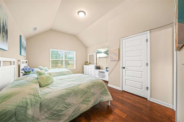 bedroom with dark hardwood / wood-style floors and vaulted ceiling