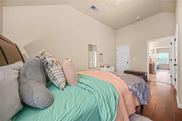 bedroom with wood-type flooring and vaulted ceiling