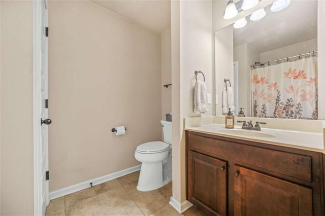 bathroom featuring vanity, toilet, and tile patterned flooring