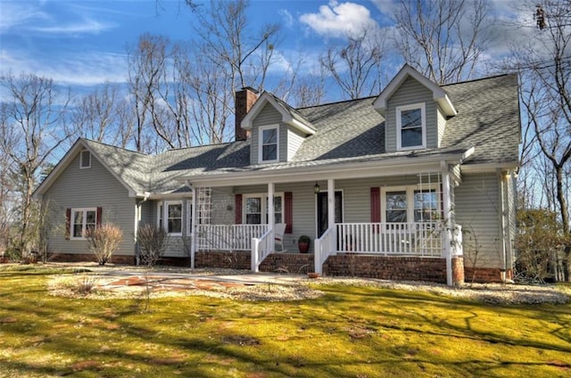 cape cod home featuring a chimney, a front lawn, a porch, and roof with shingles