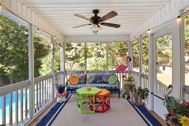 sunroom featuring ceiling fan