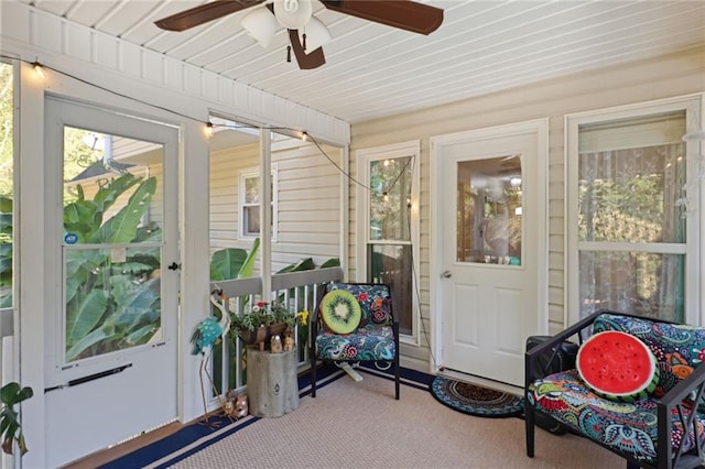 sunroom / solarium featuring ceiling fan