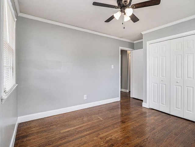 3453 Eisenhower Cir E, Atlanta, GA 30354 - unfurnished bedroom with dark wood finished floors, baseboards, crown molding, a closet, and ceiling fan