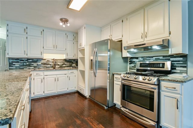 kitchen featuring a sink, white cabinetry, appliances with stainless steel finishes, under cabinet range hood, and dark wood-type flooring