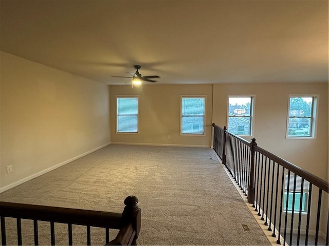 unfurnished room featuring ceiling fan and carpet flooring