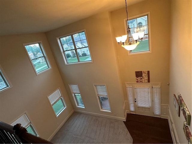 foyer with a chandelier and a high ceiling