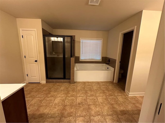 full bathroom featuring independent shower and bath, vanity, and toilet