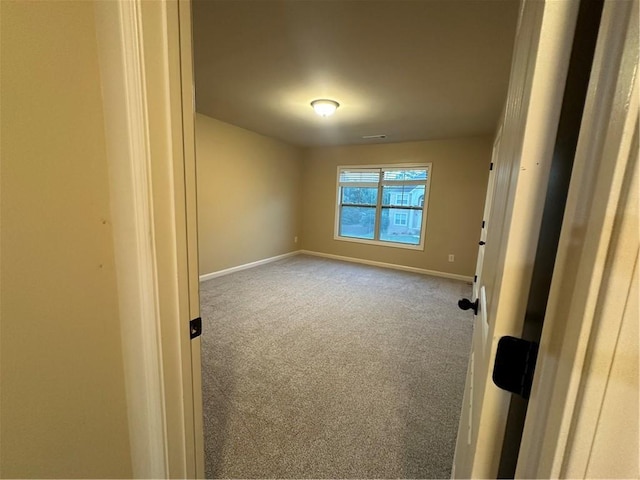 spare room featuring carpet floors