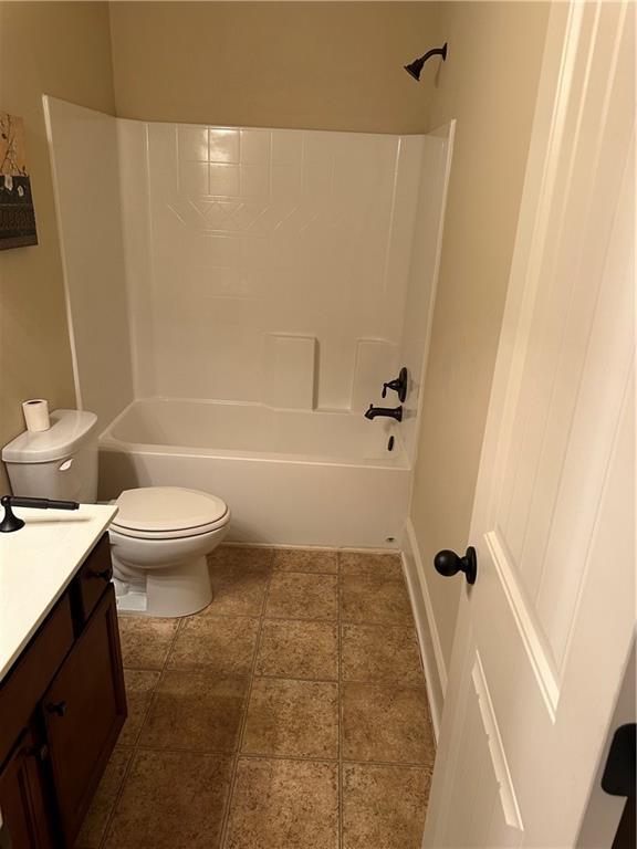 full bathroom with vanity, bathtub / shower combination, and toilet